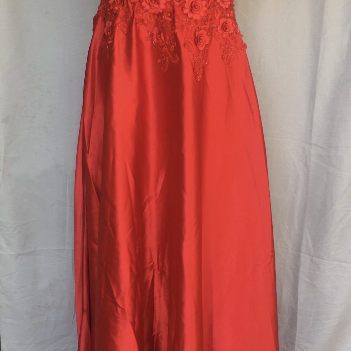 Elegant red gown with floral lace bodice and flowing satin skirt.