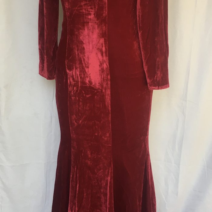 Elegant red velvet mermaid gown with embellished sheer neckline.